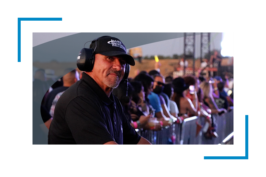Man in allied universal uniform wearing headphones as part of an event security services
